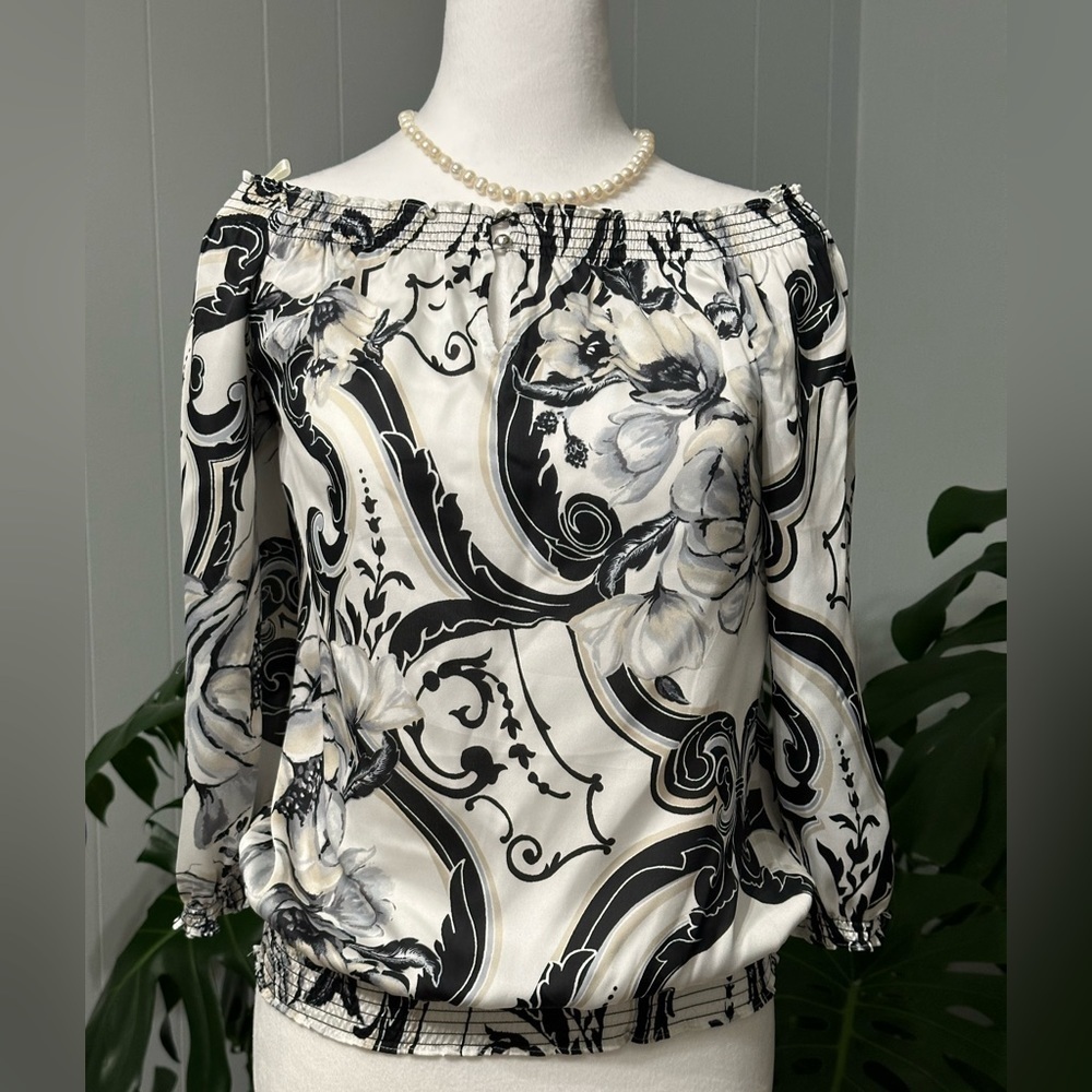 🛍️ While H. Black M. White with black floral blouse.